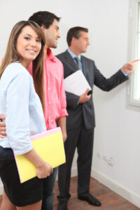 Couple viewing a house with an estate agent